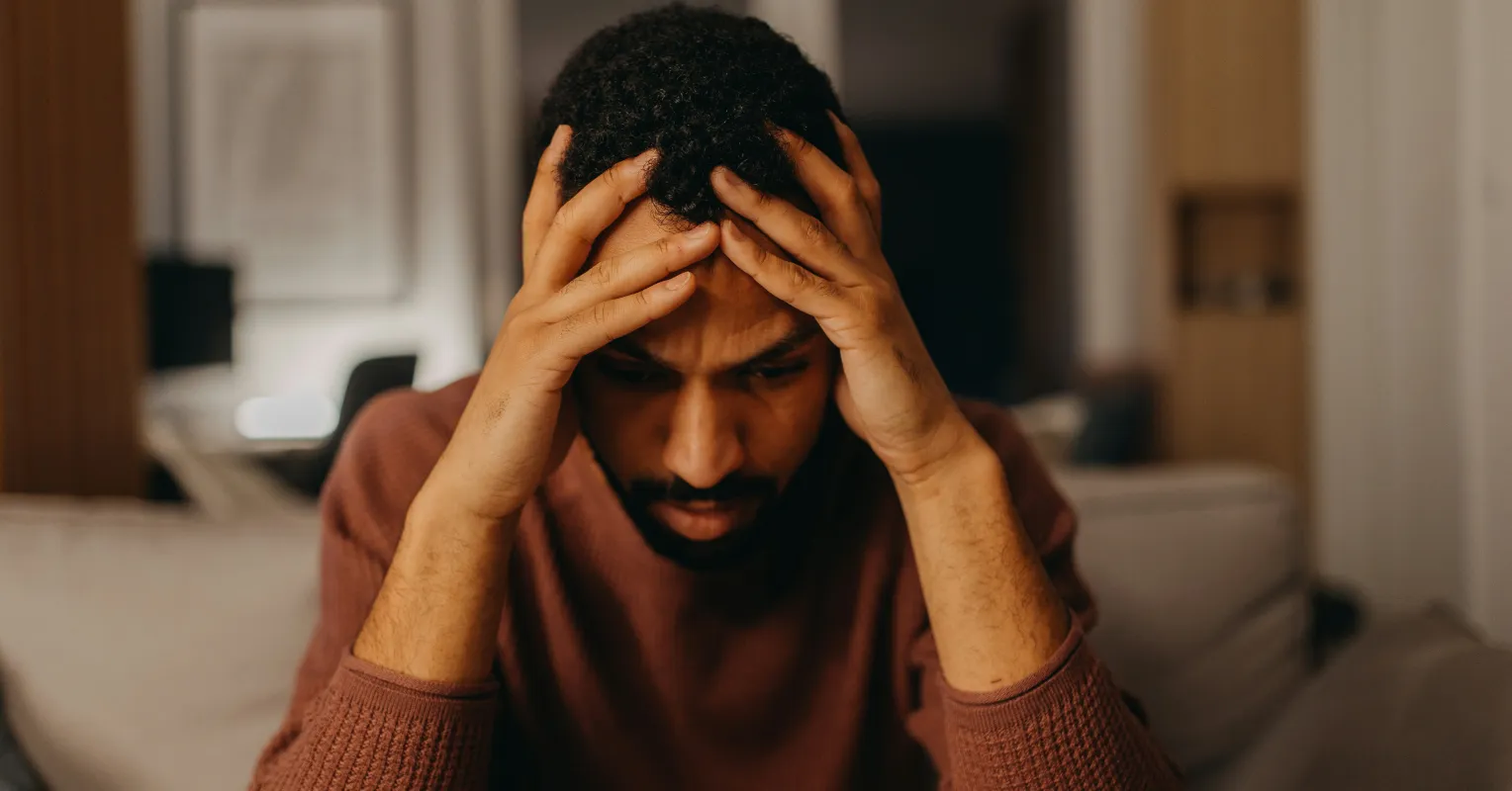 Individual contemplating the effects of feeling unsafe on emotional connections with others