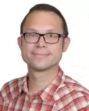 Person looking contemplative while interacting with a more attractive partner, feeling insecurity