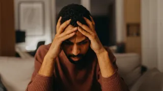 Individual feeling vulnerable in a social setting, reflecting on emotional connections and feelings of insecurity.