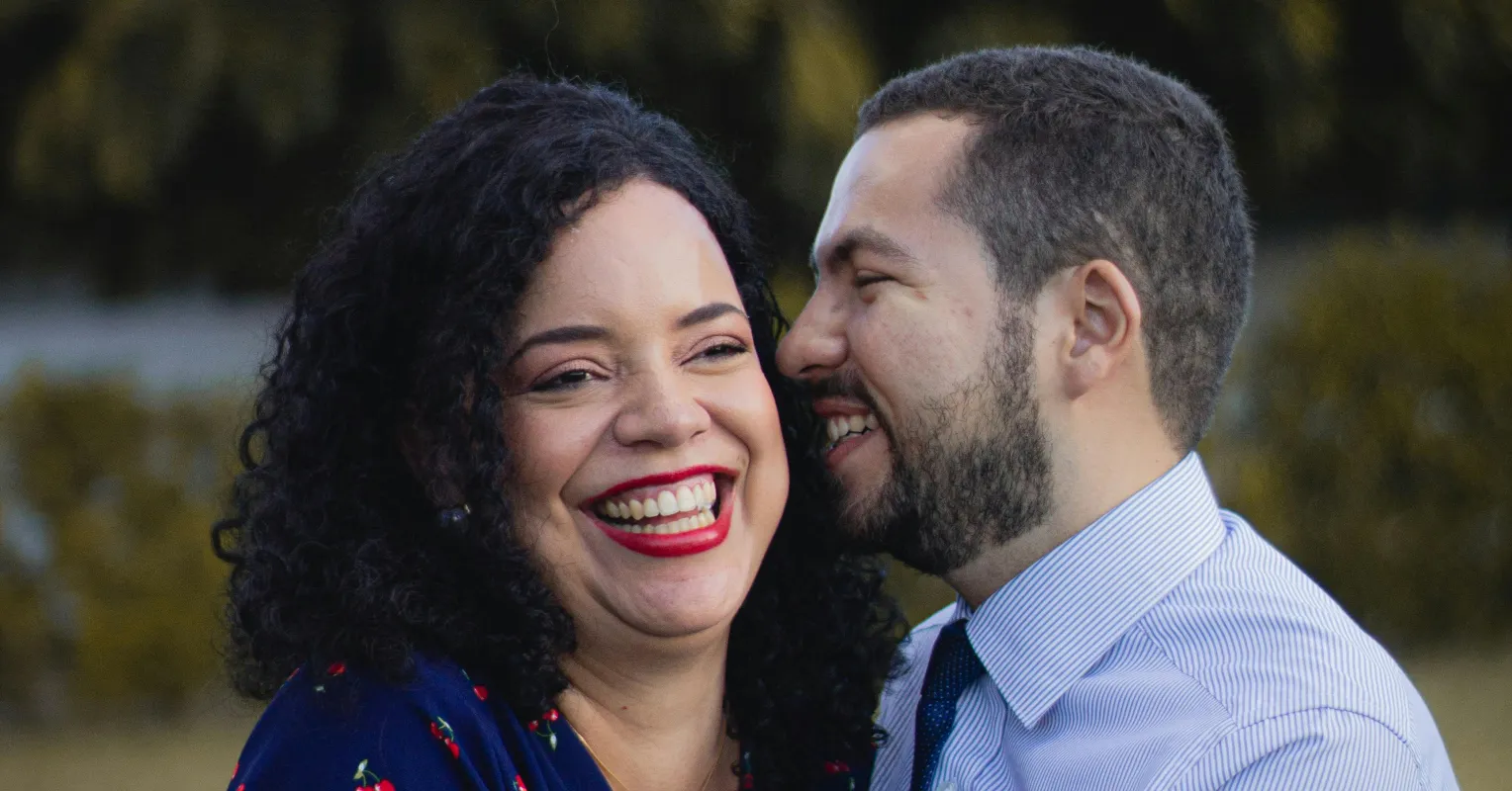 Individual contemplating commitment issues while observing a couple in a romantic embrace.