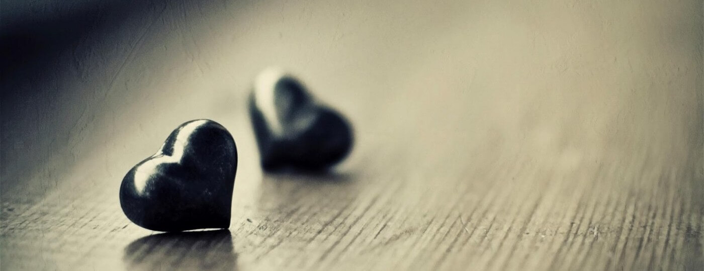 Couple sitting apart, reflecting on what it means to feel disconnected even when in love