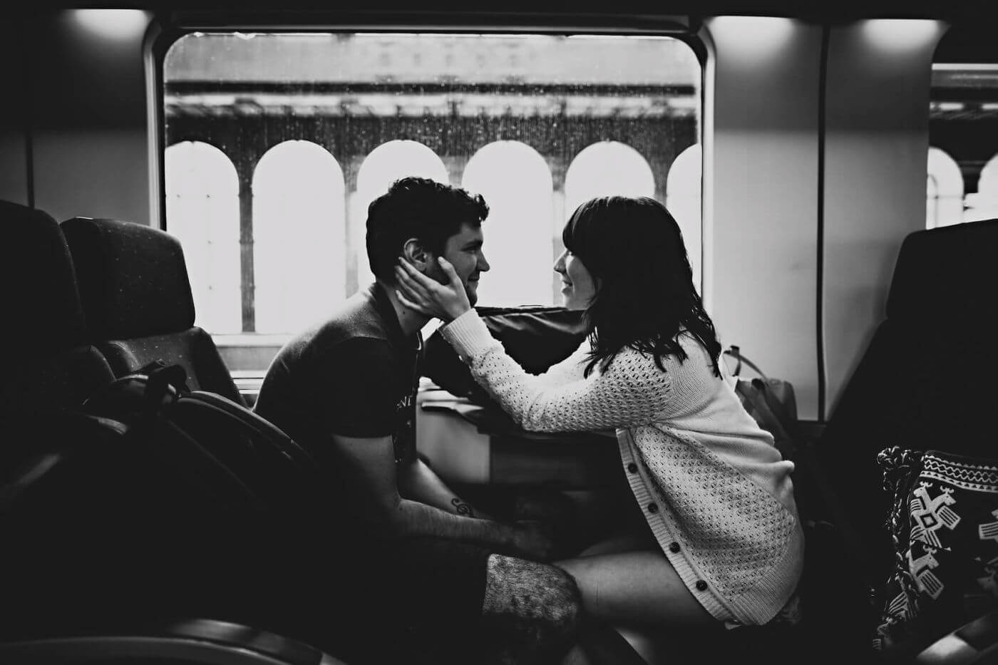 Couple video chatting while showing mixed emotions about their long distance relationship