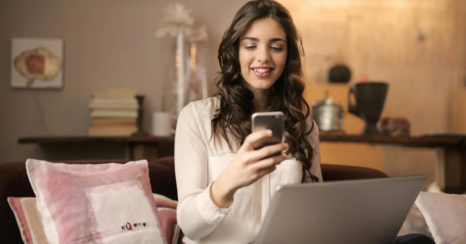 A couple smiling while listening to a voice note, exploring relationship signals of attraction