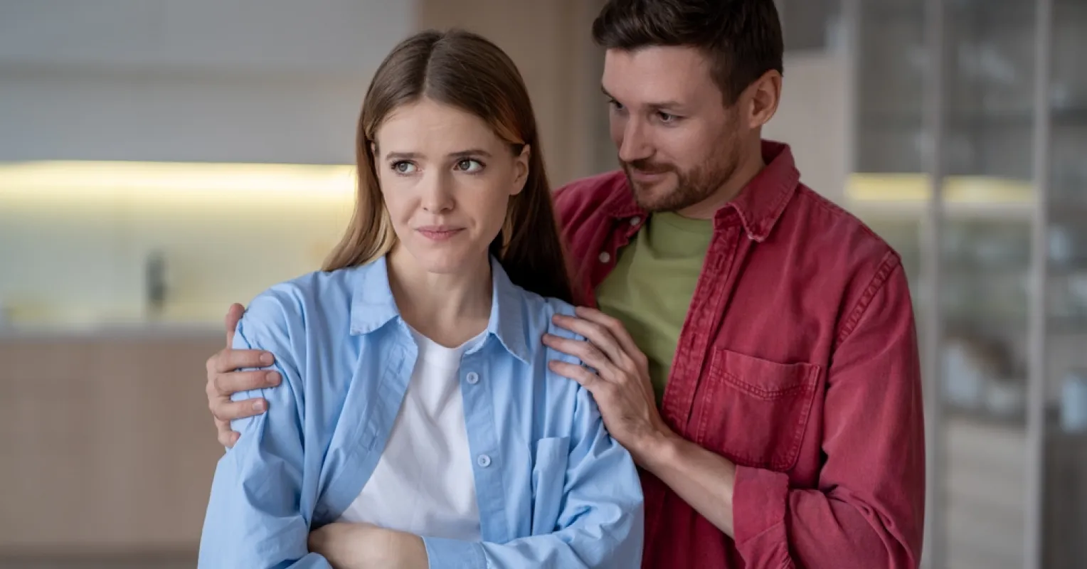 Individual contemplating feelings of betrayal in a tolyamorous relationship
