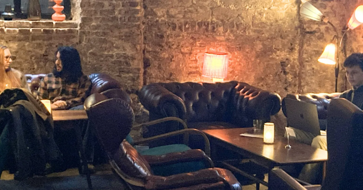 Cozy gathering with friends embodying hygge and warmth in interpersonal relationships