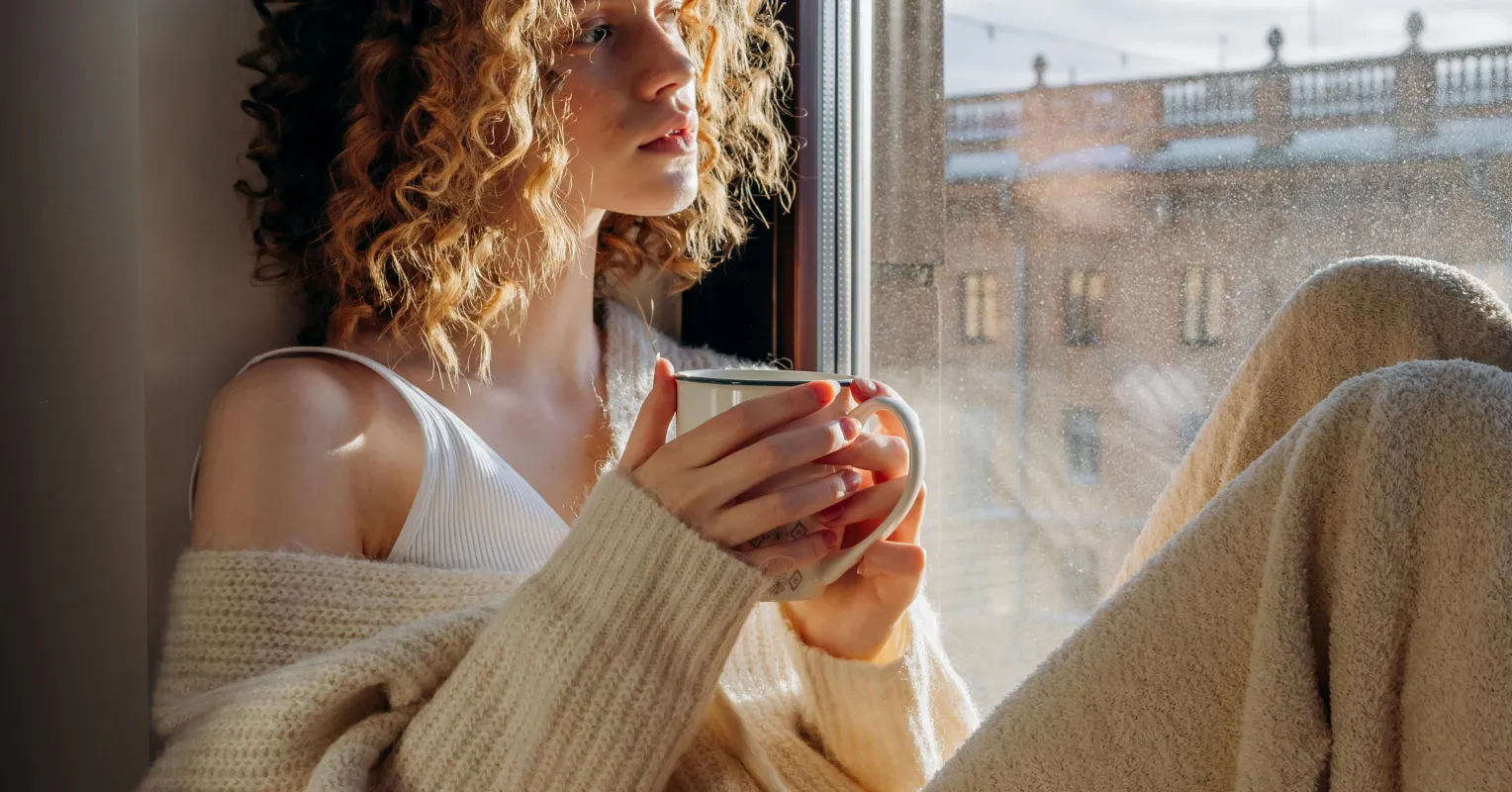 Individual contemplating unhealthy attachments while observing relationship signals in a reflective setting
