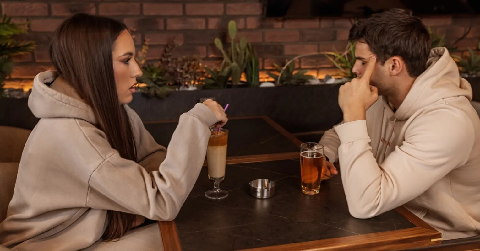 Couple discussing relationship red flags while looking concerned and attentive