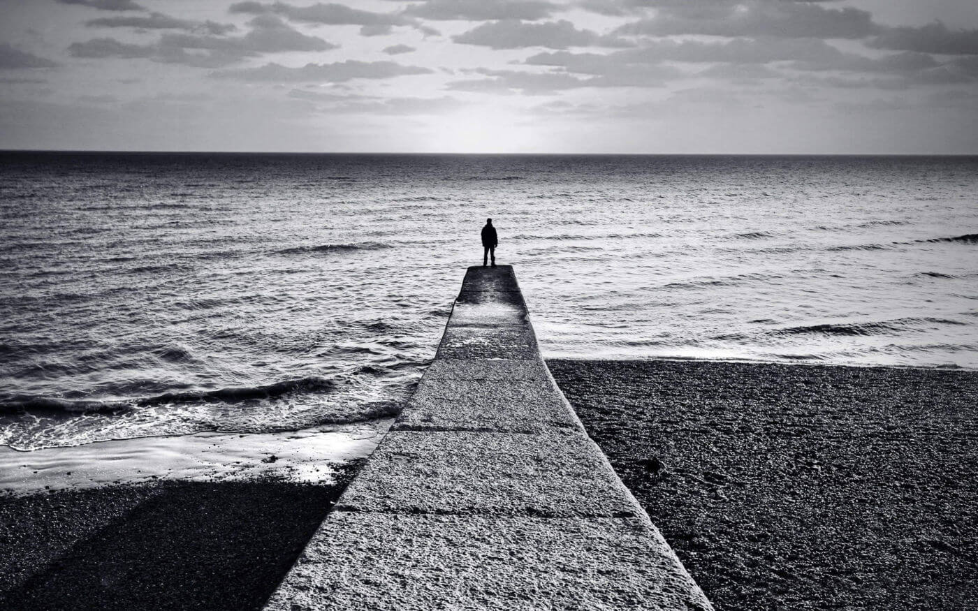 Person reflecting on uncertainty in a relationship connected to how can i tell if my partner is emotionally