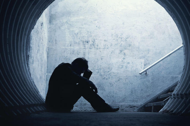Person reading a self-help book, contemplating their insecurities in relationships.