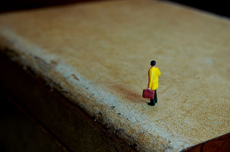 Person looking contemplatively at an empty horizon, reflecting on post-travel emptiness