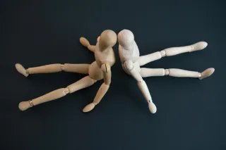 Couple sitting silently, indicating discomfort with specific topics in their relationship