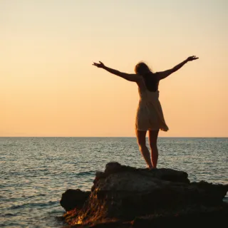 A person anxiously checking their phone, reflecting on why they panic during delayed responses.