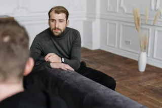 Person feeling ignored as their partner dismisses their emotional concerns during a conversation