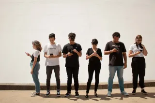 Couple experiencing tension as one partner focuses on their phone, causing insecurity.