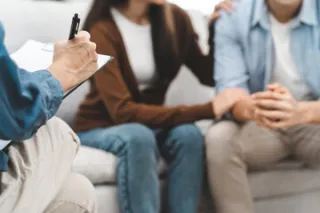 Couple in therapy discussing blame dynamics in their relationship