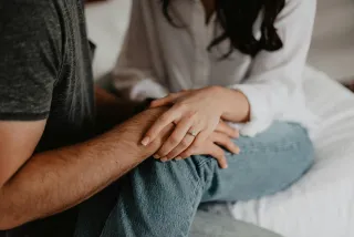 Couple sitting apart, reflecting on sudden changes in affection and relationship signals