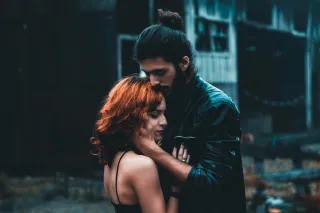 Individual contemplating self-abandonment patterns while examining their relationship dynamics