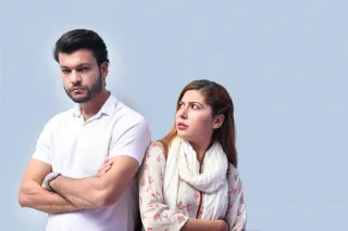 Couple sitting apart, reflecting on emotional distance despite mutual care