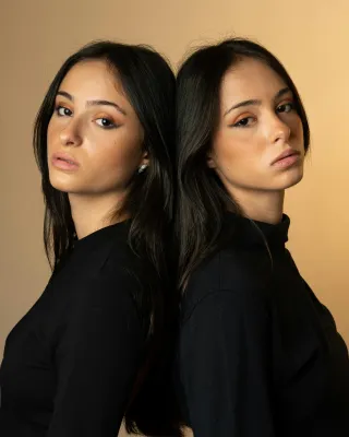 Twin siblings share a moment of understanding, highlighting the discomfort in meeting new people.