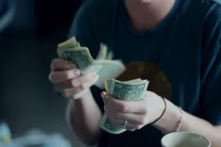 Woman contemplating her feelings about discussing finances in a relationship context