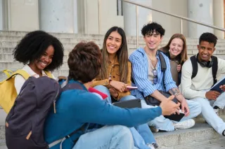 Individual contemplating feelings of exclusion while trying to connect with new friends in a social setting
