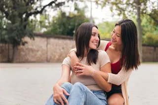 Couple sitting in silence, hinting at emotional distance despite reassurances of everything being fine.