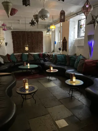 Cozy gathering of friends sharing laughter, illustrating hygge in interpersonal relationships