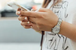 Couple looking troubled as one partner focuses solely on their phone