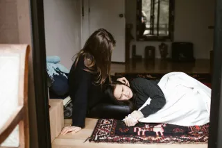 Person contemplating their past relationship while trying to engage with a new partner