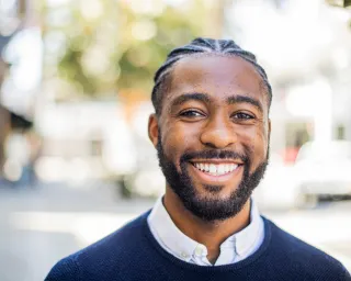 A stranger sharing a warm smile, revealing hidden social dynamics and connection