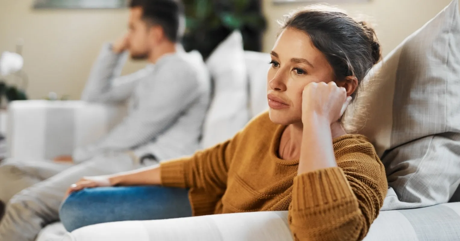 Person reflecting on subtle cues indicating their partner is losing interest while hiding it