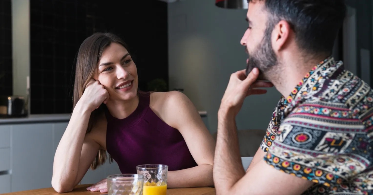 Couple sitting together but appearing distant, indicating signs your partner may not be ready to open the relationship