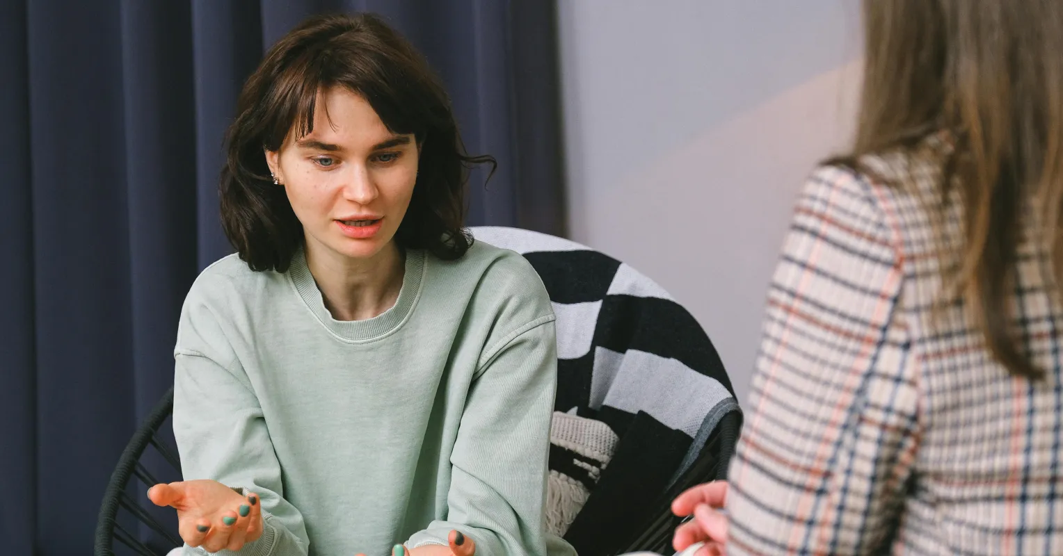 Therapist and client engaged in a deep conversation, showing emotional connection and understanding