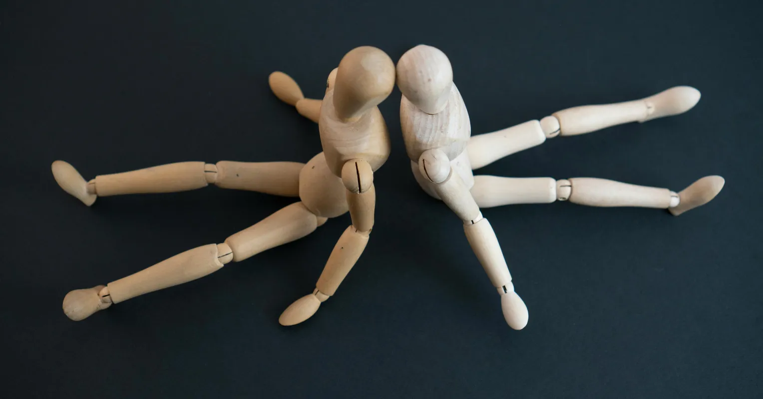 Couple sitting in silence, navigating emotional signals when topics become uncomfortable