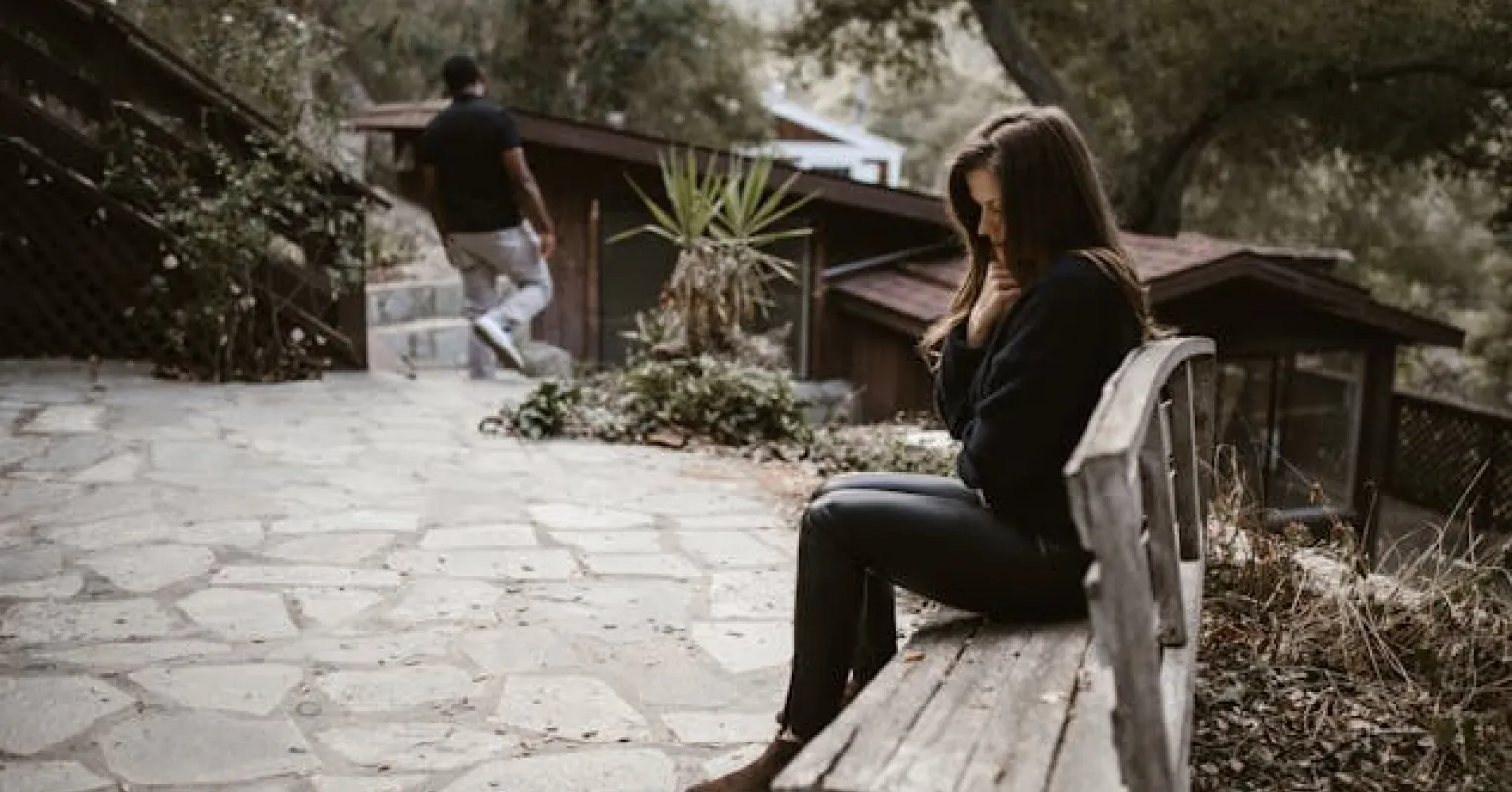 Person contemplating their emotions while seeking closure after a breakup