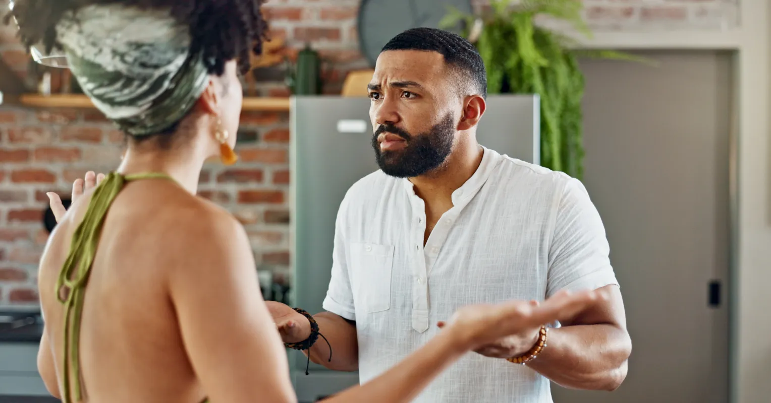 Couple sitting silently, showcasing the challenge of avoiding emotional conversations in relationships