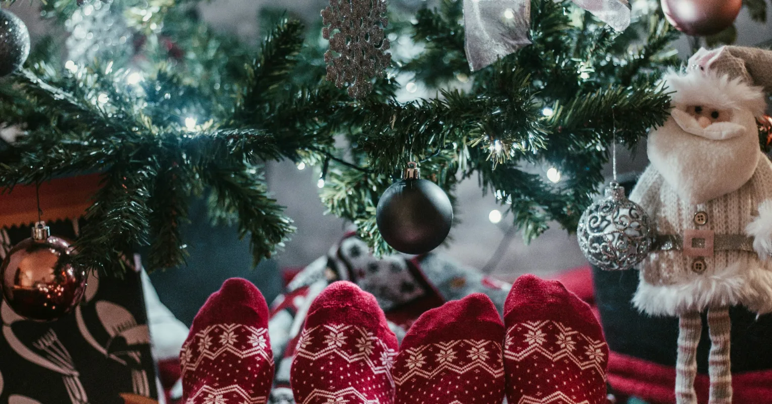 Couple sitting apart, reflecting on emotional distance during the holidays
