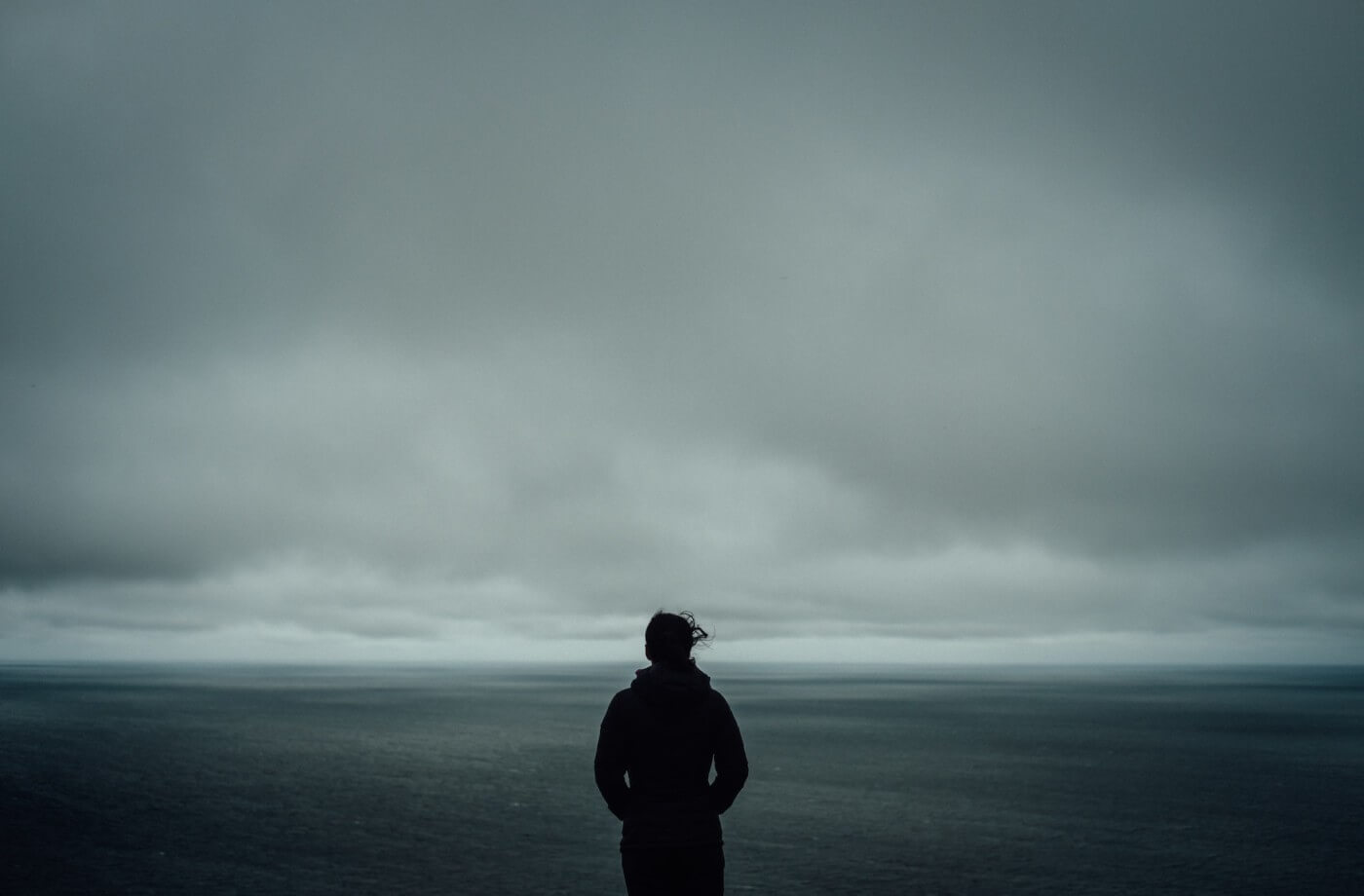A couple sitting in silence, showcasing unspoken emotional distance during a lonely moment.
