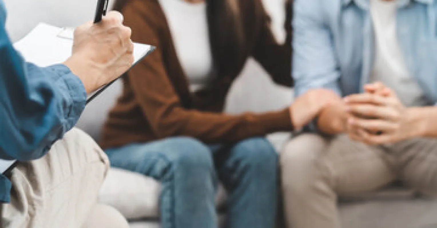Two partners arguing during a therapy session, highlighting blame in relationships