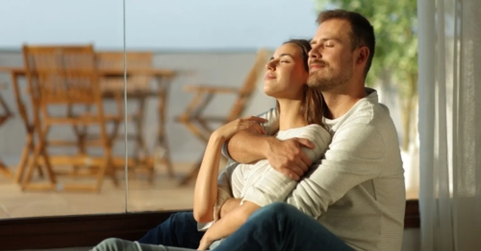 Couple sitting apart, showing anxiety about communication in their relationship.