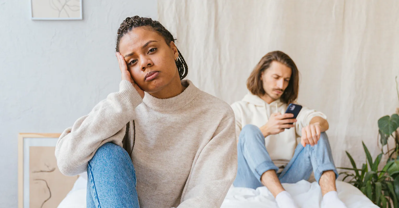 Couple sharing an intimate moment but appearing emotionally distant and disconnected
