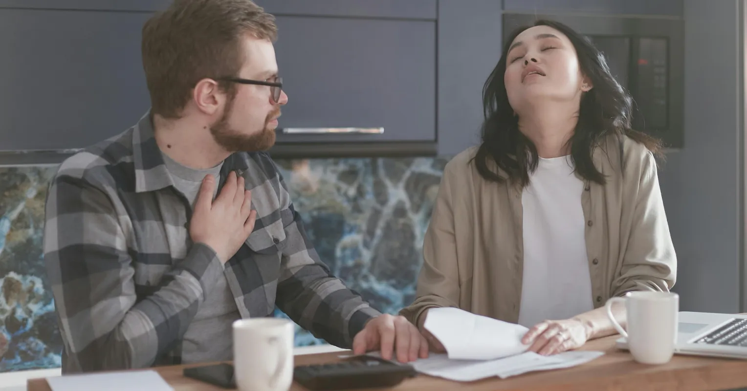A couple discussing financial decisions, revealing emotional tension over spending habits