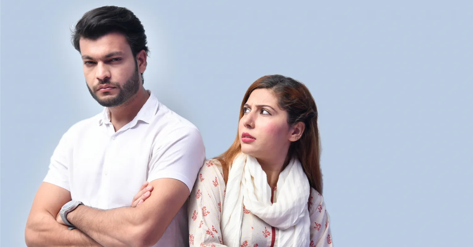 Couple sitting together but feeling emotionally distant despite caring for each other