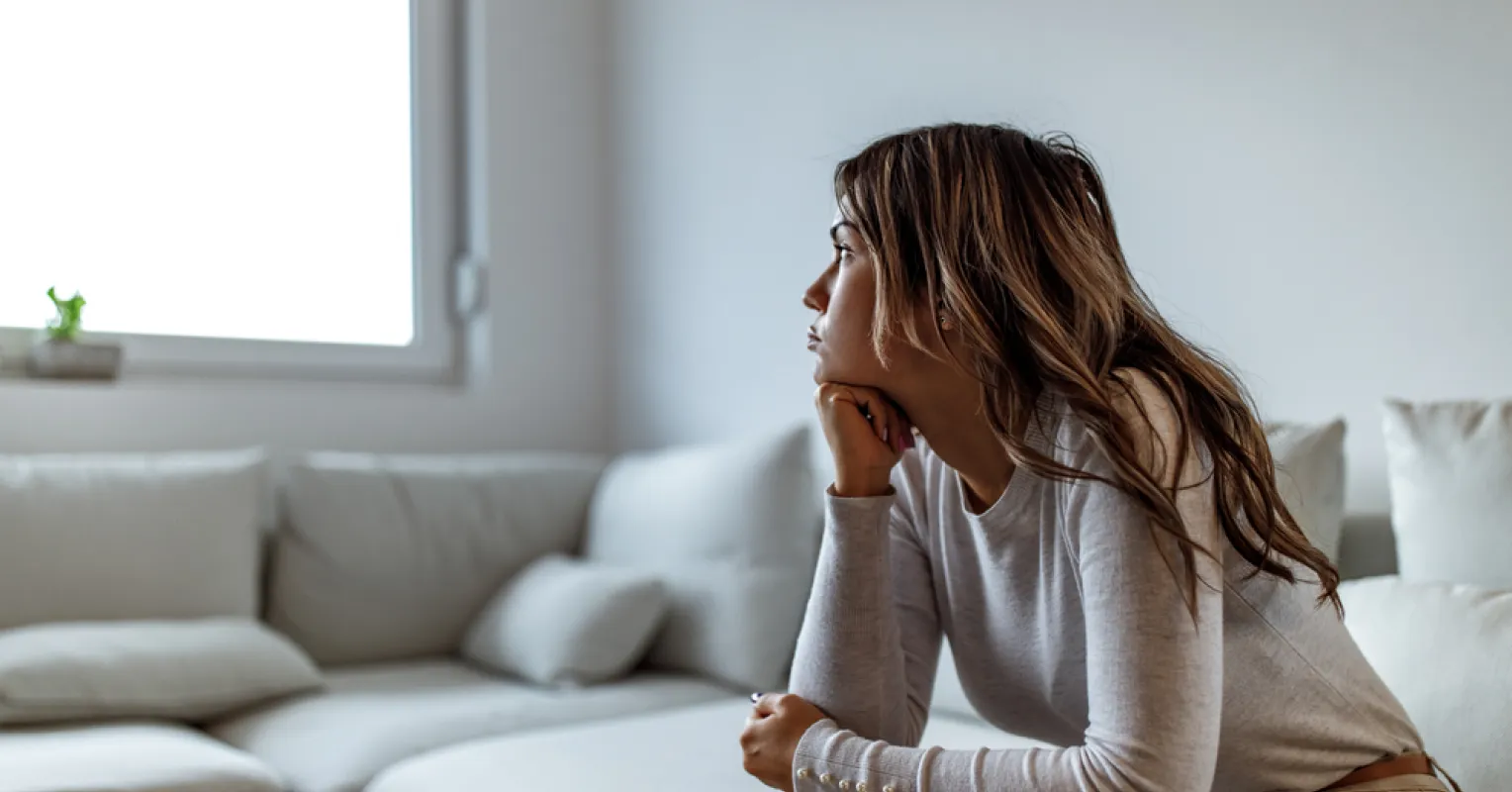Person feeling hesitant while attempting to share thoughts during a conversation