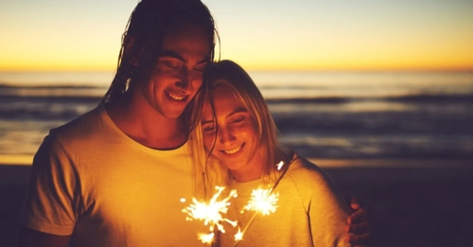Couple sharing a moment of reassurance and connection during New Year's celebrations