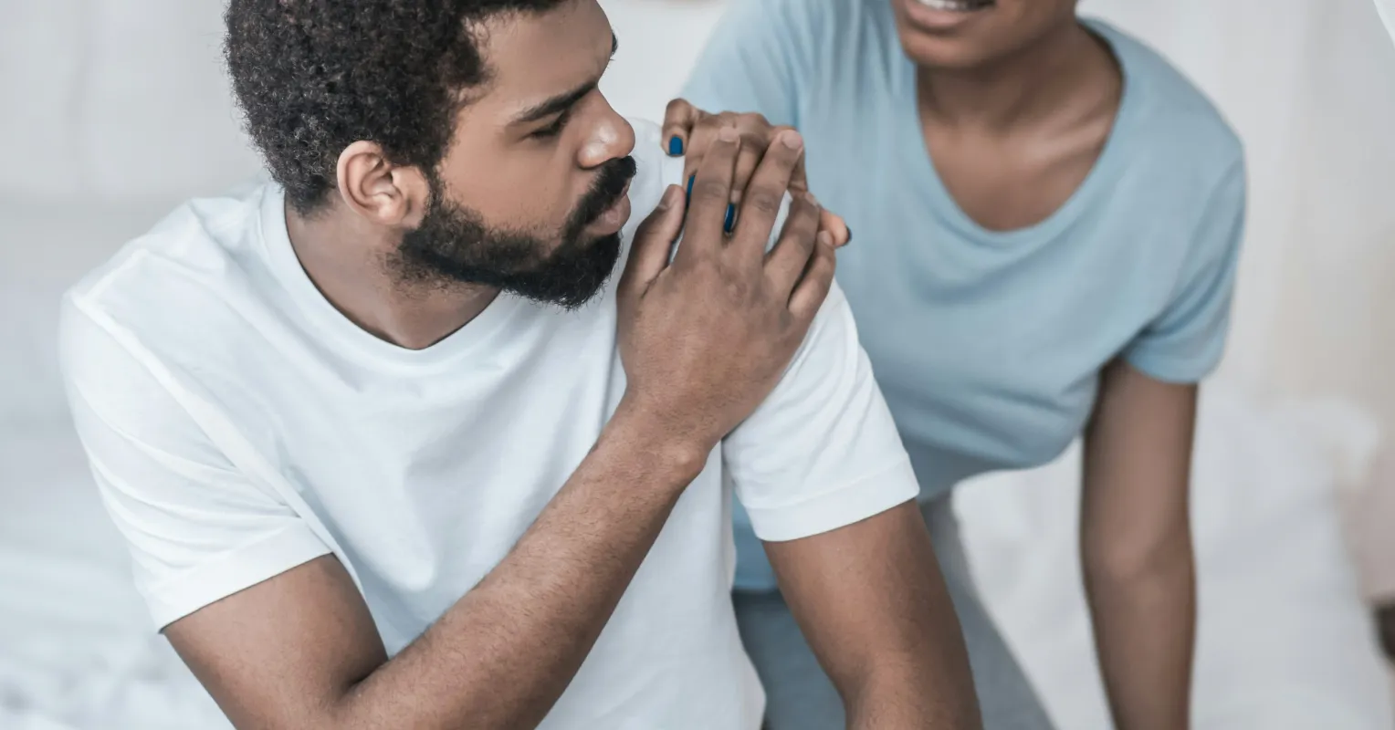 Individual contemplating emotional barriers during a challenging discussion about feelings