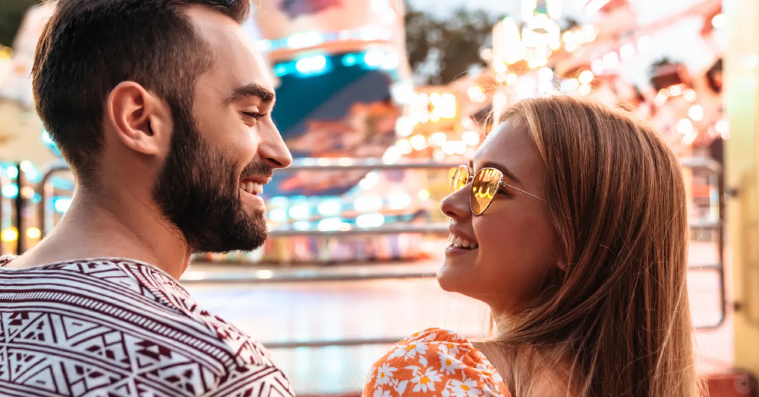 Person looking away, signaling distraction during a date conversation, prompting questions about relationship signals.
