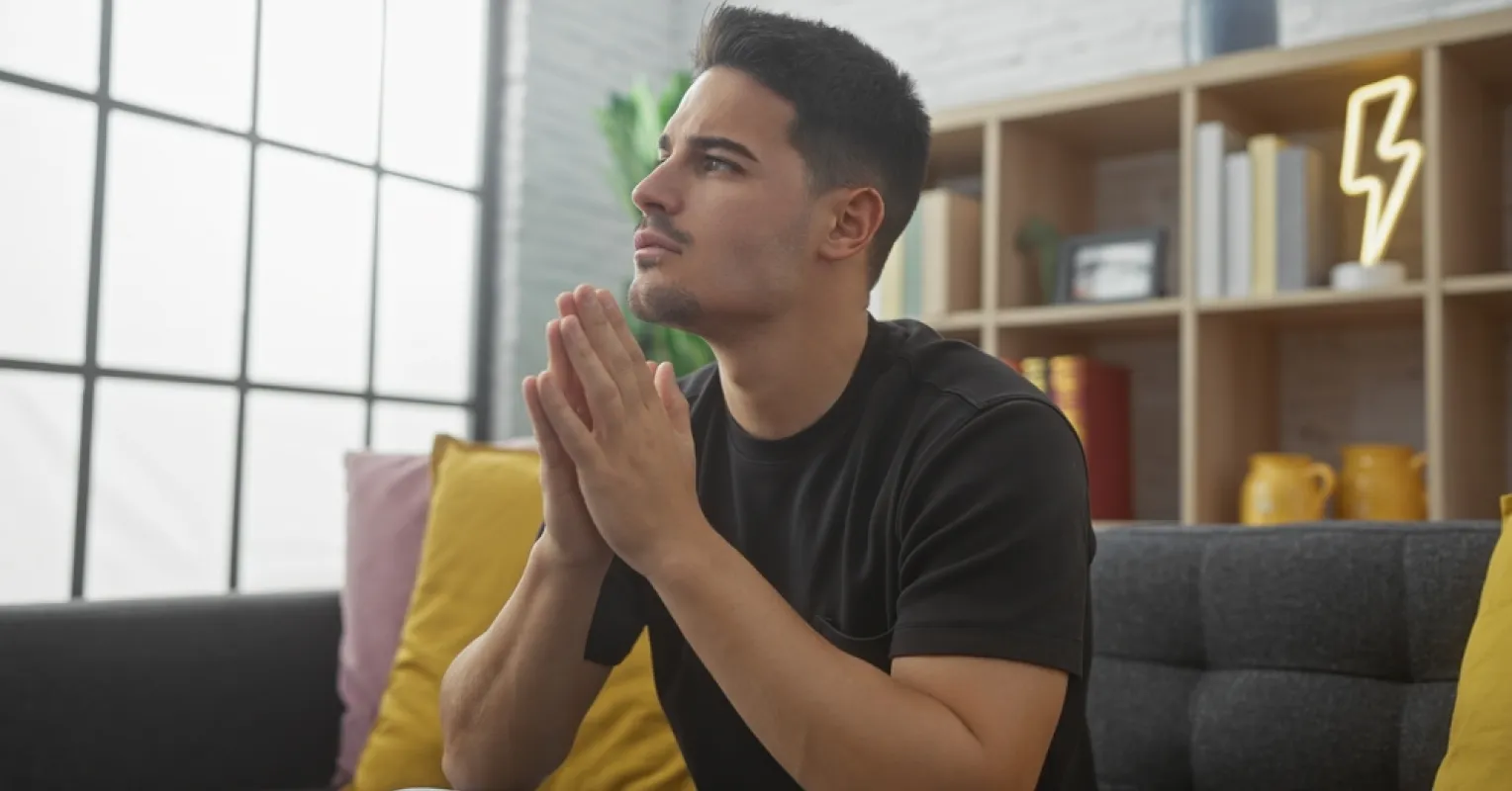 Couple sitting together yet displaying emotional distance after an apology for betrayal
