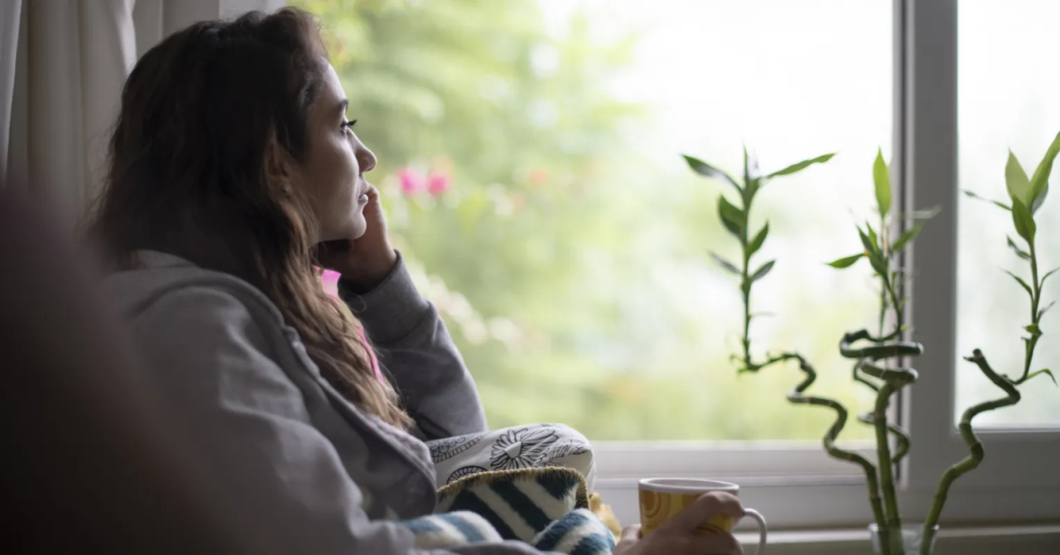 Person contemplating feelings of invisibility in a relationship despite ongoing efforts