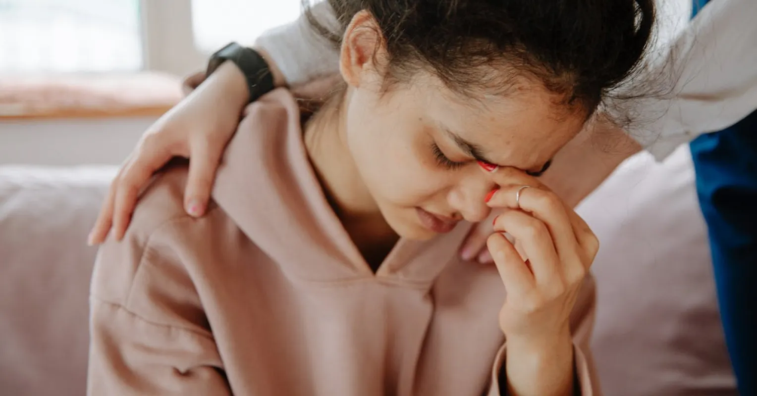 Individual feeling isolated in a group setting, despite friends' presence after a breakup